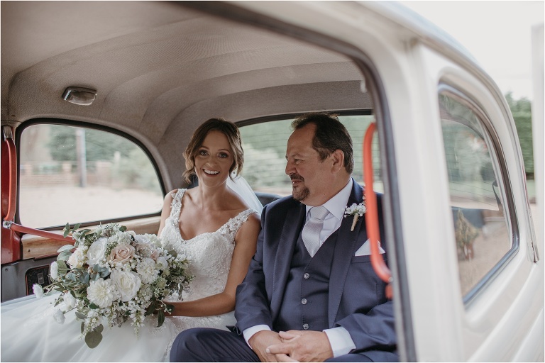 Bride and Father of the bride arrive in wedding car for ceremony at Old Kent Barn