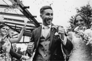 Bride and groom walk down the aisle after wedding ceremony at Old Kent Barn