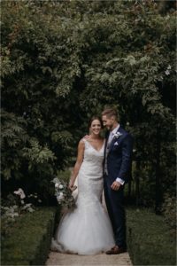 Portraits of bride and groom in the gardens of Old Kent Barn