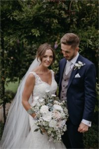 Portraits of bride and groom in the gardens of Old Kent Barn