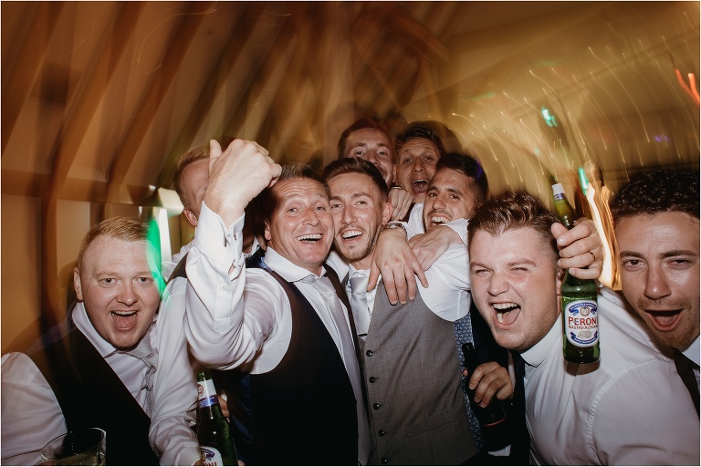 Groom and friends together on dance floor at Old Kent Barn.