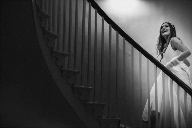 Bride walks upstairs at Clissold House wedding